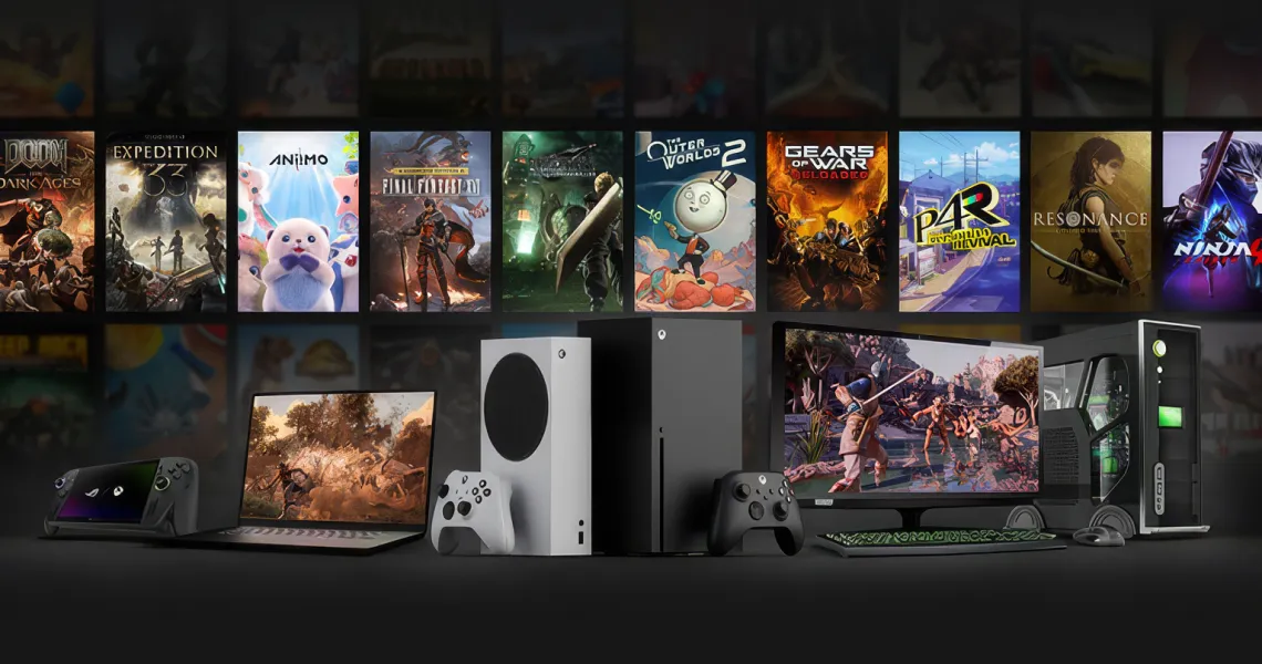 Xbox consoles, a PC and a handheld in front of a wall of game covers